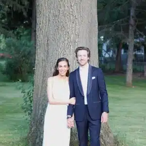 Bride and groom in font of a tree.